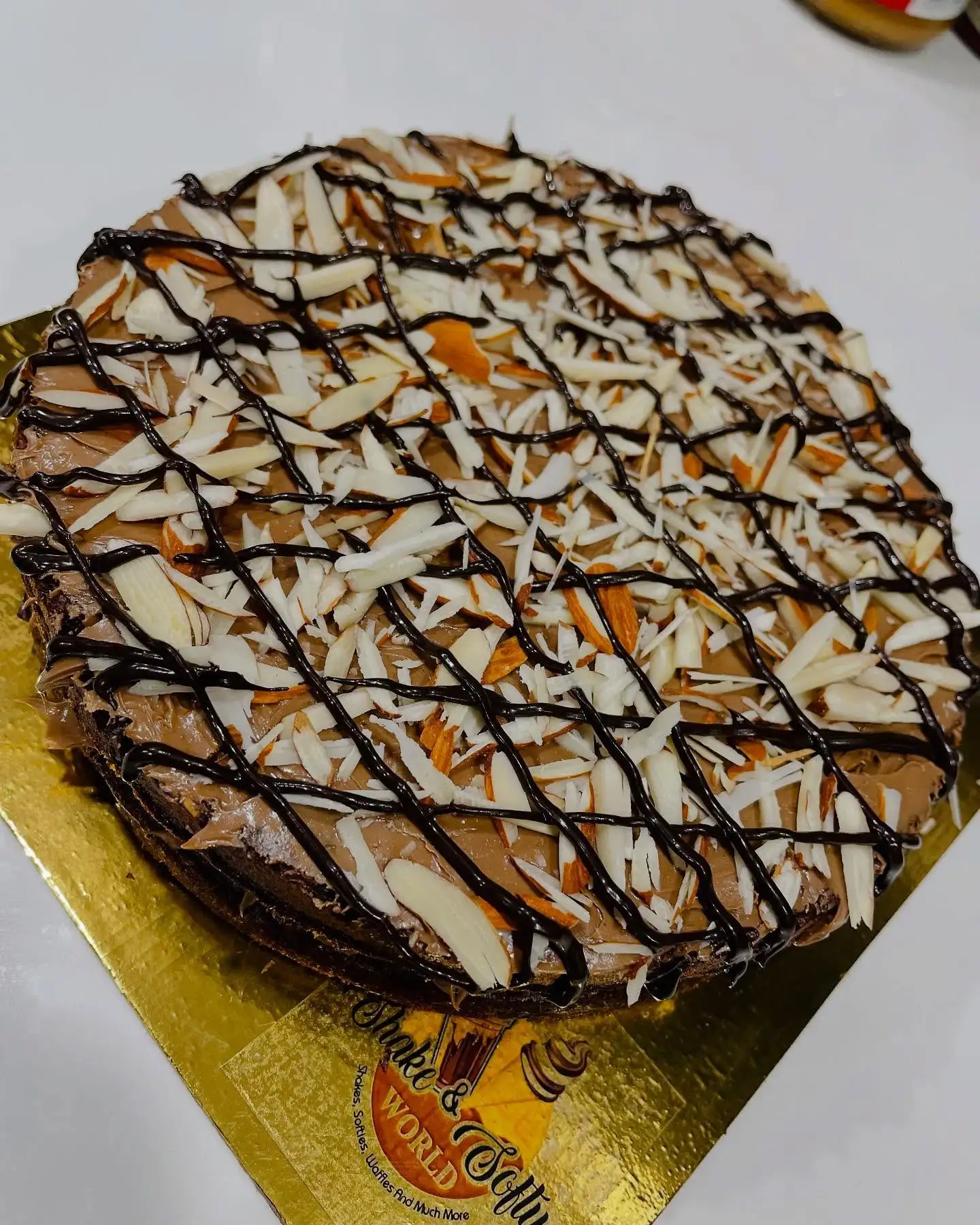 Chocolate almond cream cake topped with chocolate drizzle at Shivansh Food Park