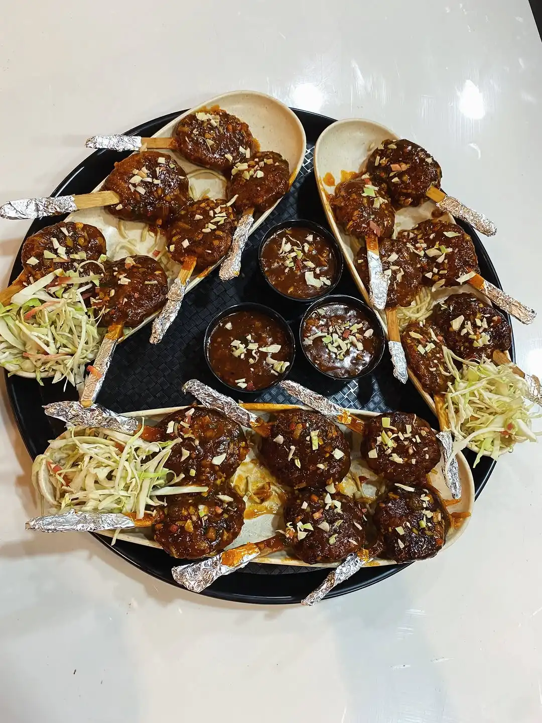 Crispy soya chaap lollipops plated with dips and salad at Shivansh Food Park
