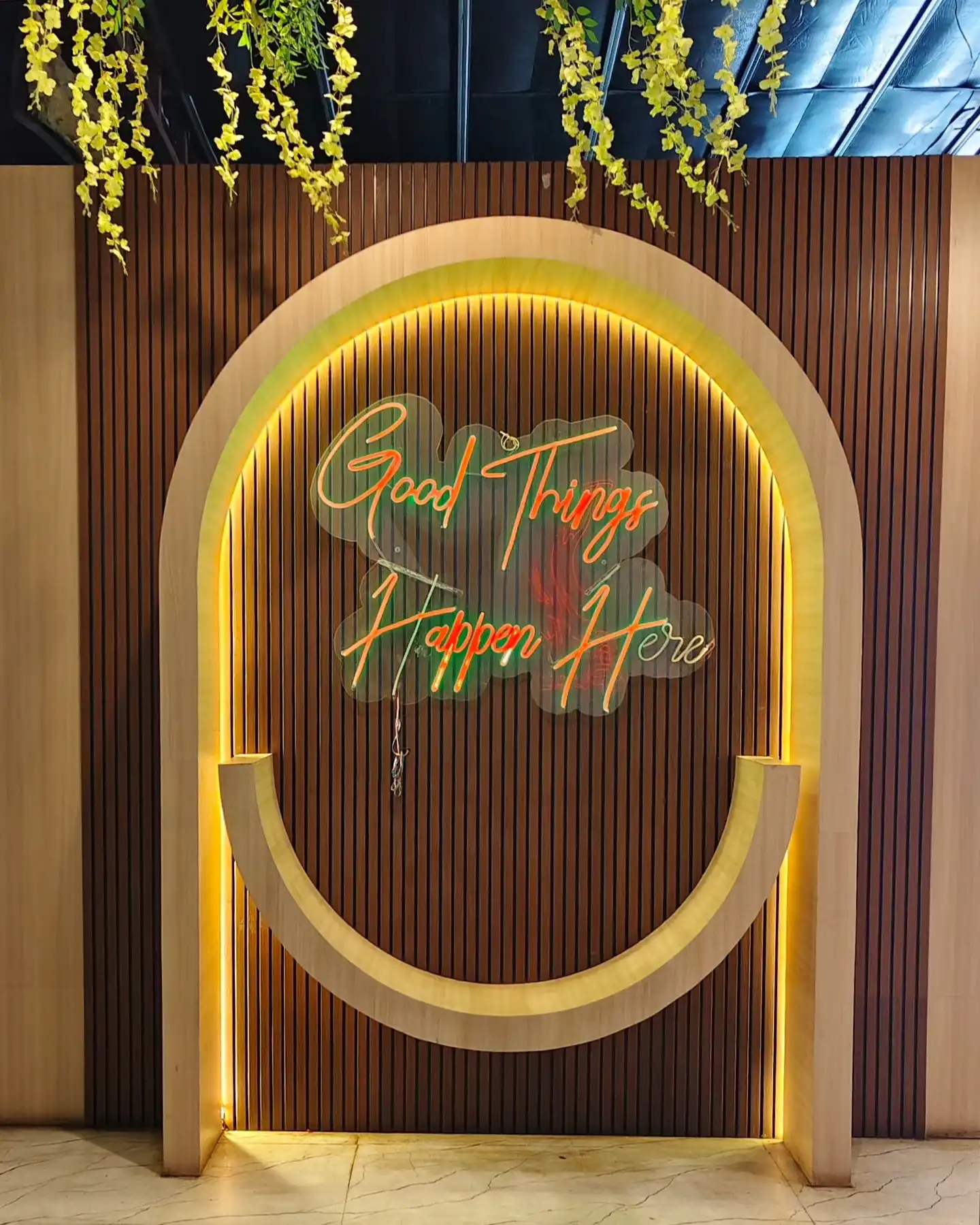 Warm lit Good Things Happen Here neon arch selfie point at Shivansh Food Park