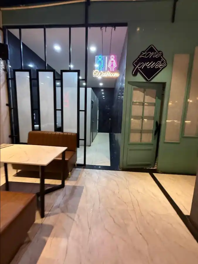 Cozy cafe corner with marble tables inside Shivansh Food Park