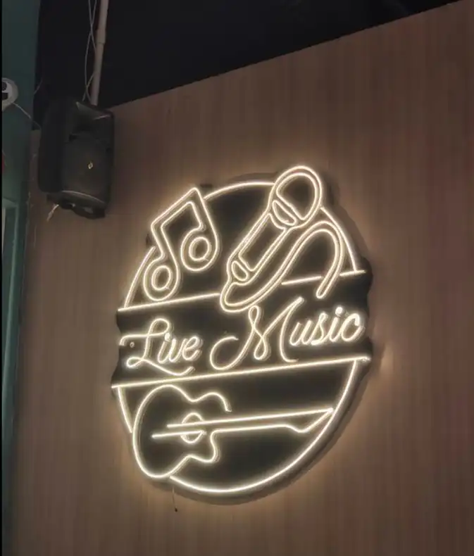 Live Music neon sign on wooden wall at Shivansh Food Park Dhamtari